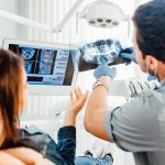 Dentist clinic consultation with dentist explaining x-ray to patient